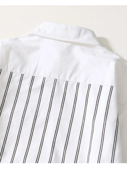 Close-up of a white shirt with black vertical stripes on a light background