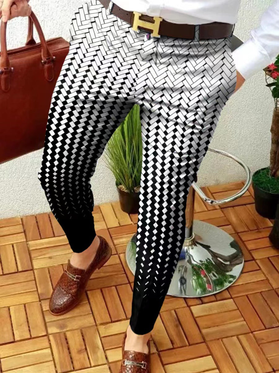 Person wearing black and white patterned pants with a brown belt, standing on a wooden floor.