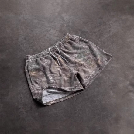 Pair of gray shorts on a dark gray background