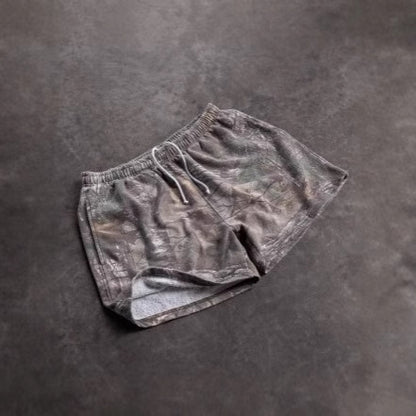Pair of gray shorts on a dark gray background