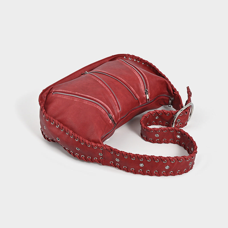 Shoulder bag with zipper details on a white background.
