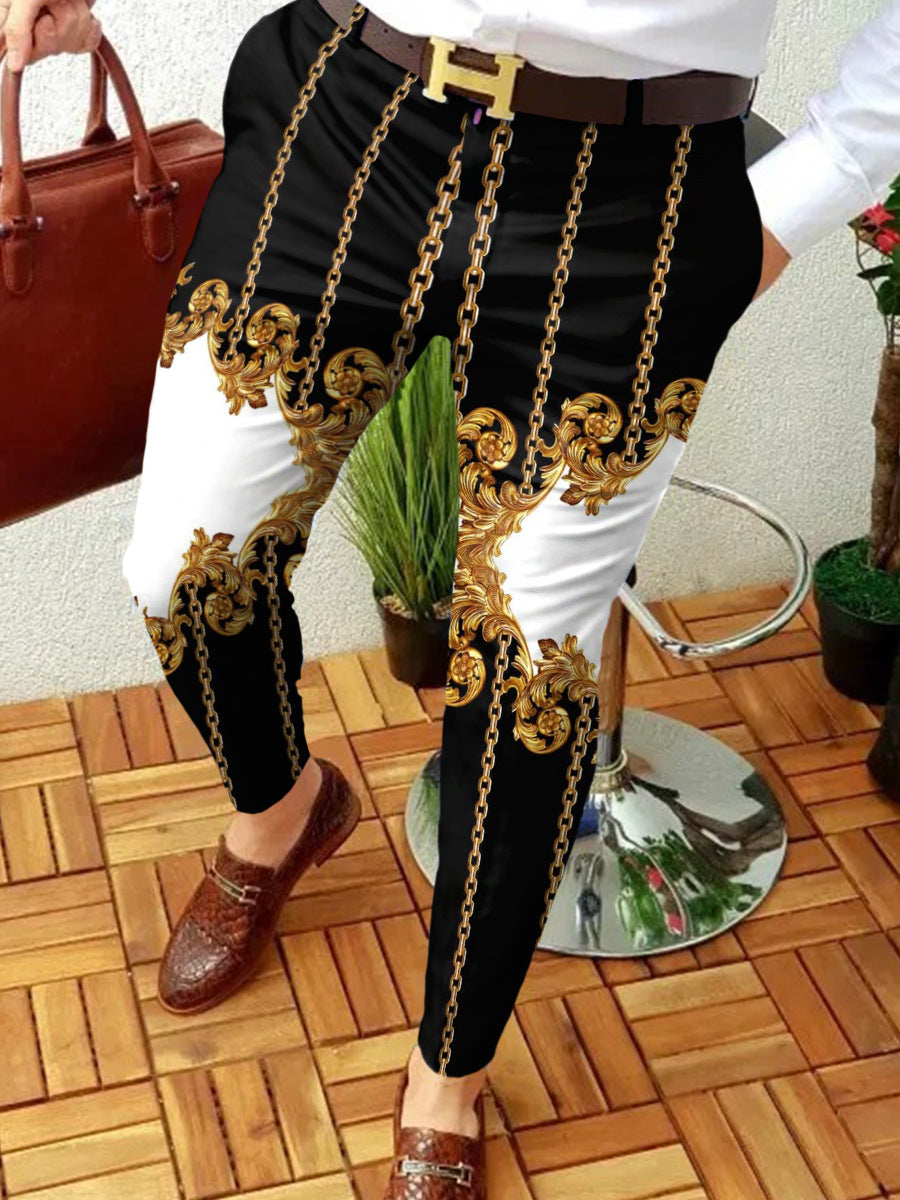 Person wearing black pants with gold chain details on a wooden floor.