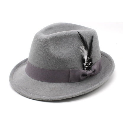 Gray fedora hat with a purple band and feather on a white background