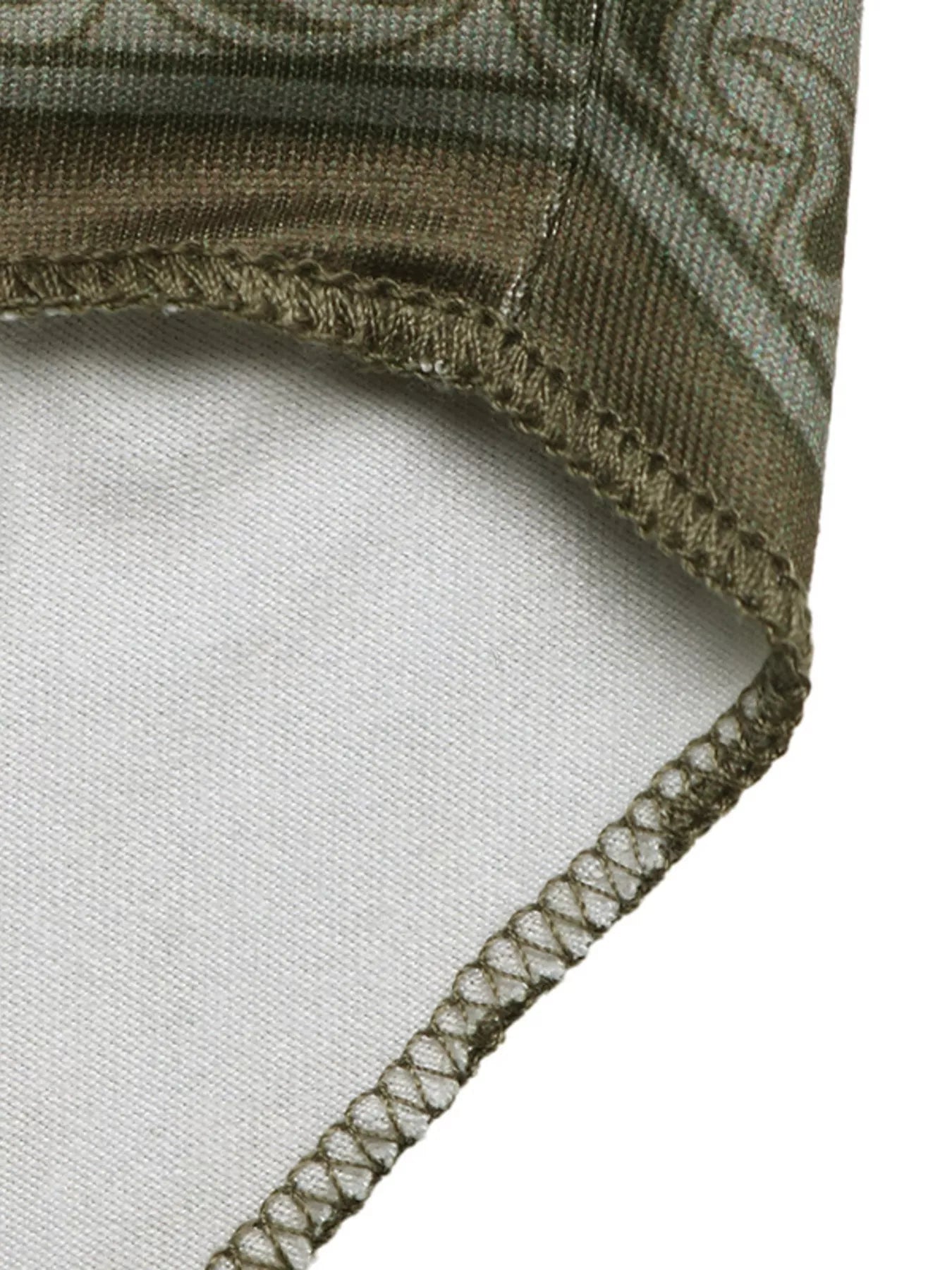 Close-up of a folded fabric with intricate patterns on a white background