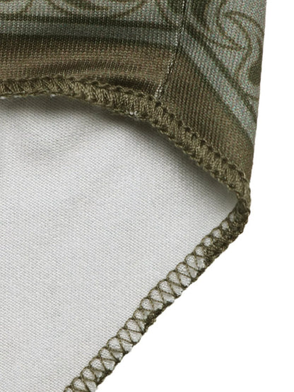 Close-up of a folded fabric with intricate patterns on a white background