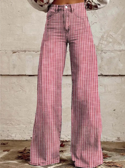 Pink plaid pants worn by a person against a textured wall.