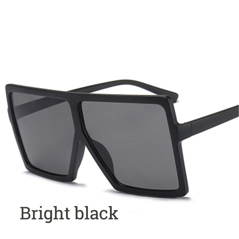 Black sunglasses with dark lenses on a white background