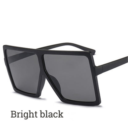 Black sunglasses with dark lenses on a white background