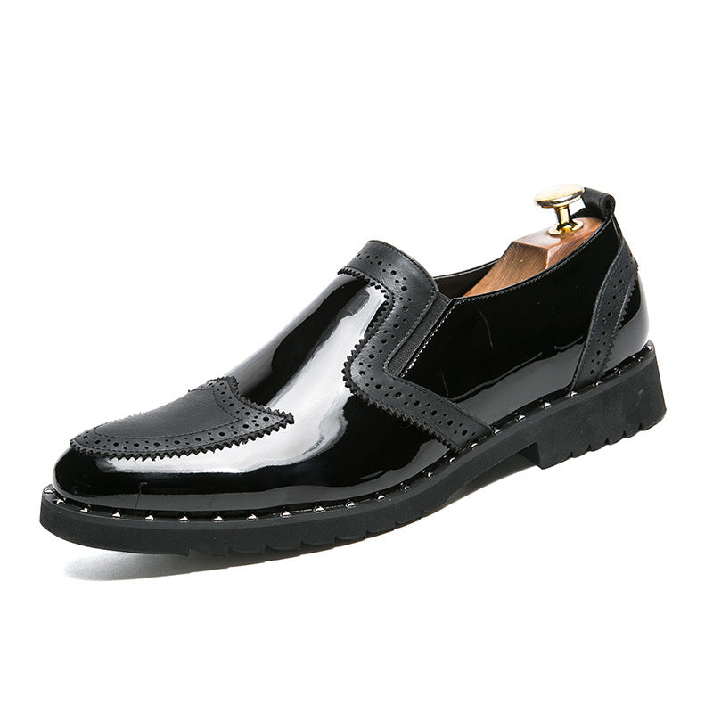 Black glossy leather shoe with gold buckle on a white background