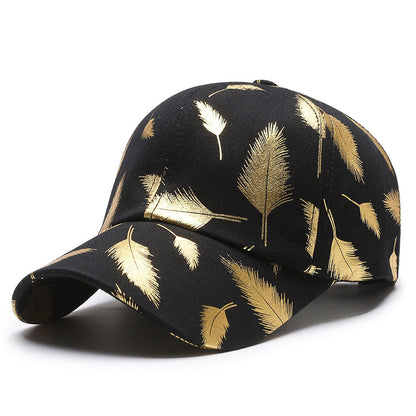 Black cap with gold leaf pattern on a white background