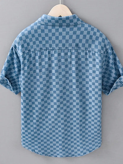 Blue checkered shirt on a hanger against a gray background