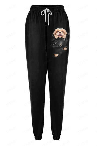 Black sweatpants with a dog graphic on a white background