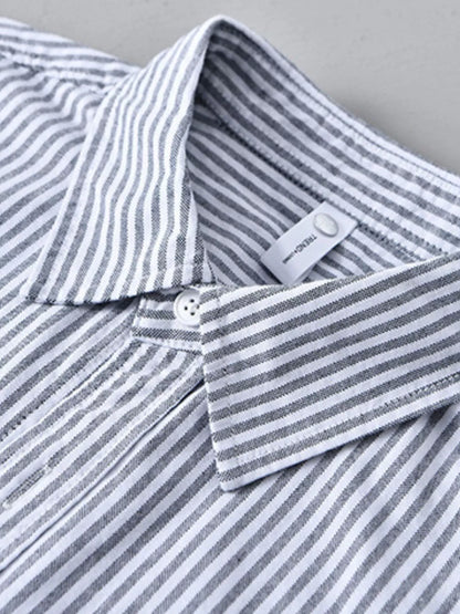 Close-up of a striped shirt with a brand label on a gray background