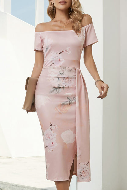 Woman wearing a pink off-shoulder dress with floral patterns outdoors.