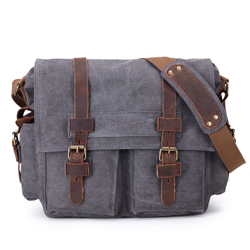 Gray canvas bag with brown leather straps on a white background