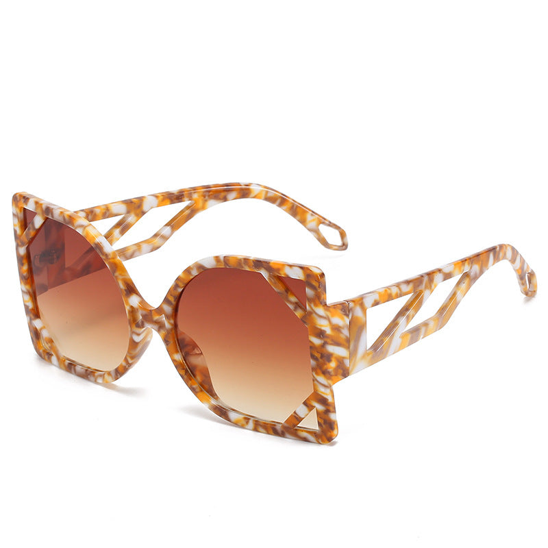 Sunglasses with tortoiseshell frame and brown gradient lenses on a white background