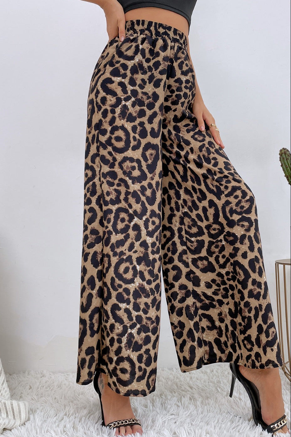 Leopard print pants worn by a person on a white background
