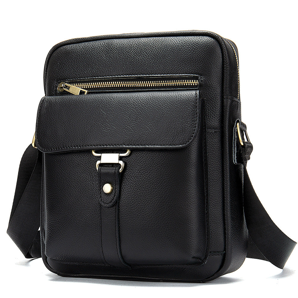Black leather crossbody bag with gold zipper on a white background