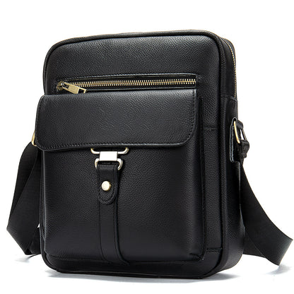 Black leather crossbody bag with gold zipper on a white background