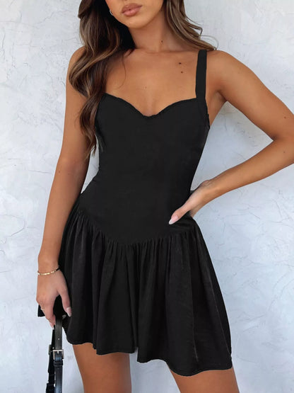 Woman wearing a black dress against a white background