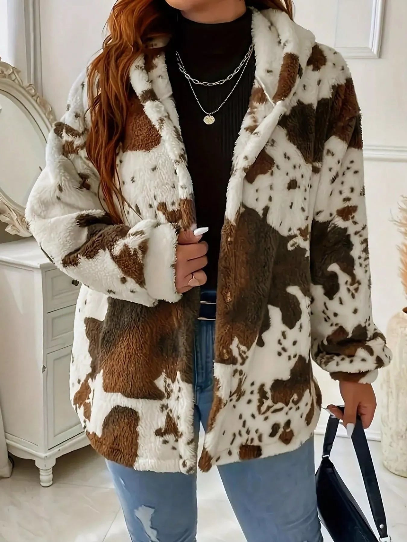 Person wearing a cow print coat in an indoor setting