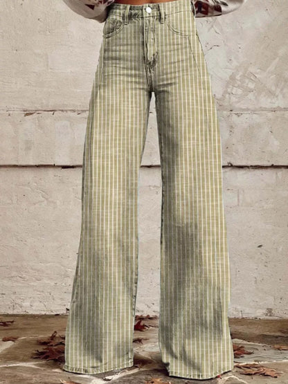 Green plaid pants worn by a person against a concrete wall.