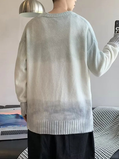 Person wearing a light gray sweater taking a mirror selfie.