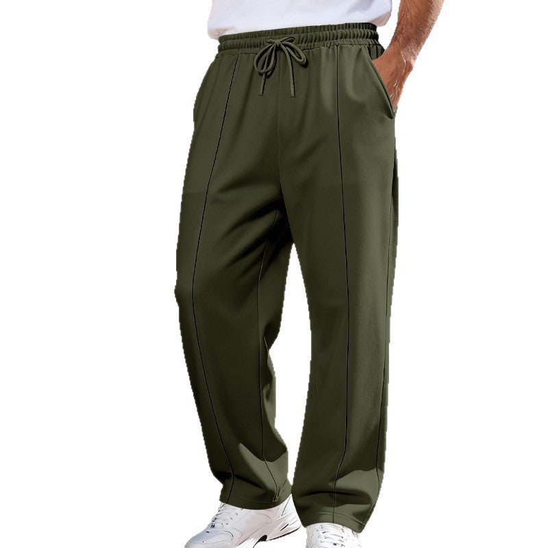 Green pants worn by a person on a white background