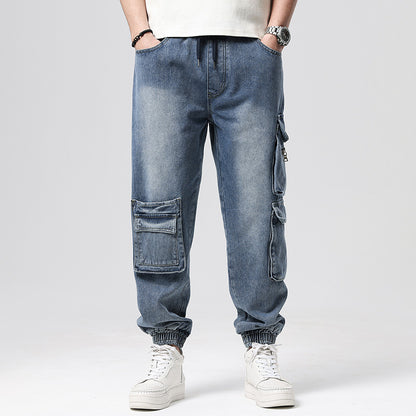 Person wearing blue cargo jeans with multiple pockets on a plain background