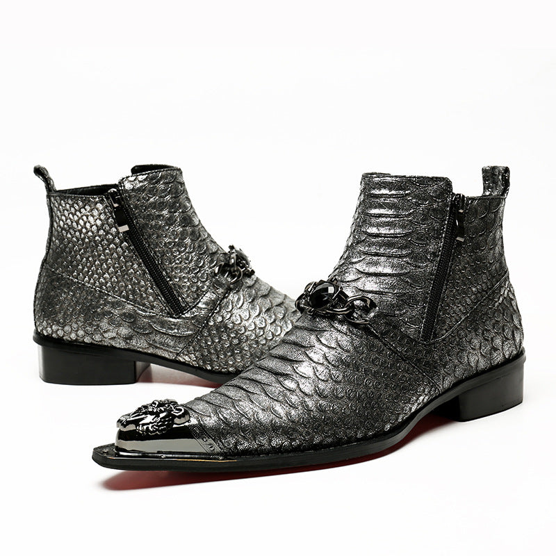 Silver metallic boots with detailed design on a white background