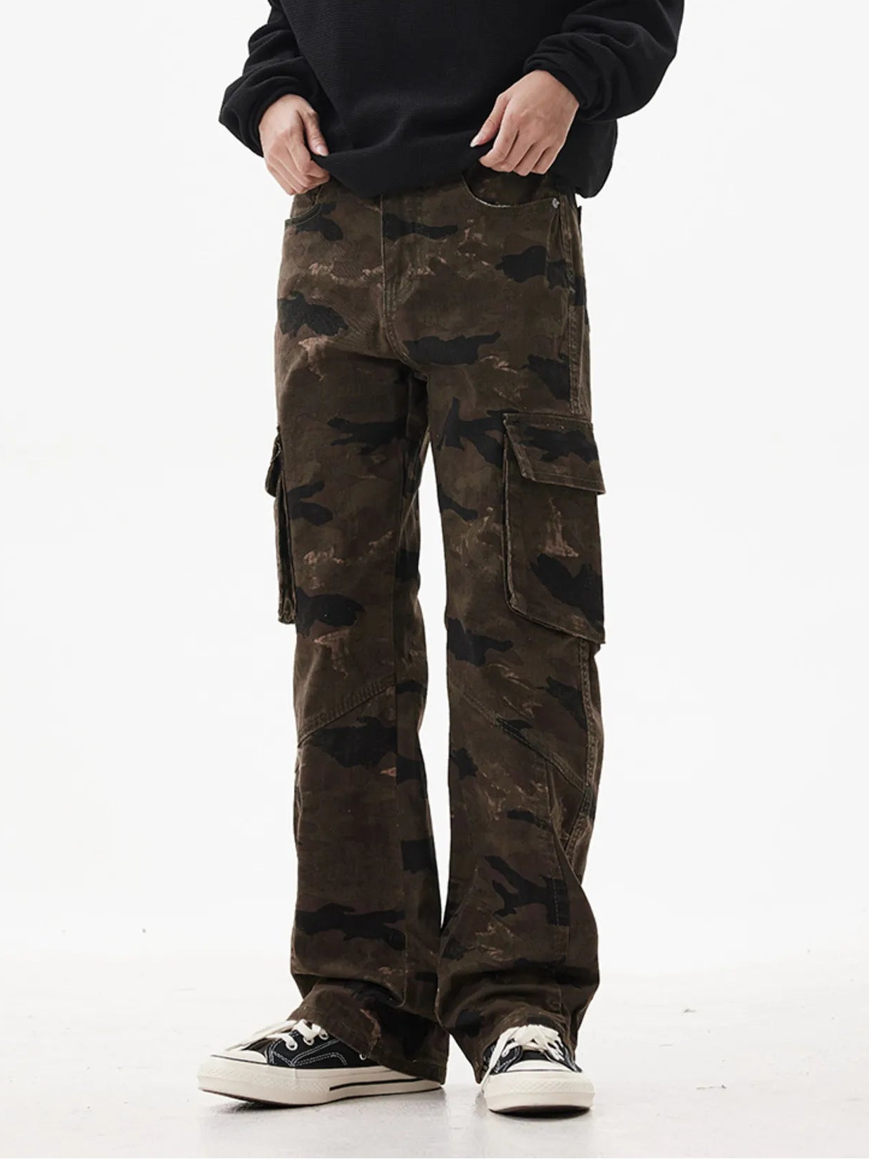 Person wearing camouflage cargo pants on a white background