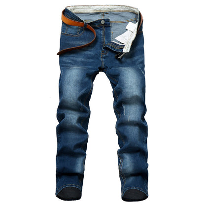 Blue jeans with a brown belt on a white background