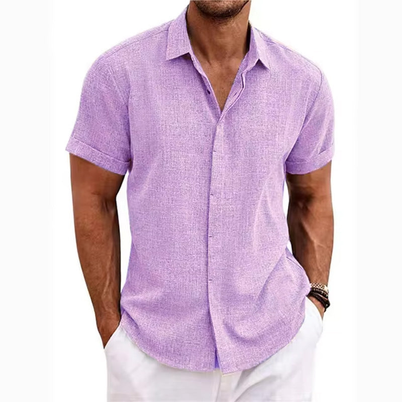 Man wearing a light purple short-sleeve shirt and white pants on a white background