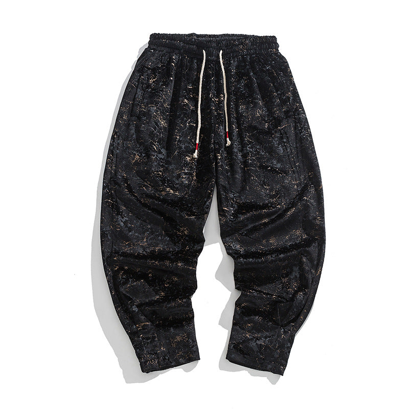 Black distressed sweatpants with a drawstring on a white background