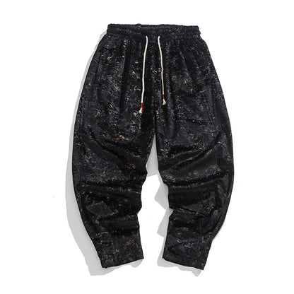 Black distressed sweatpants with a drawstring on a white background