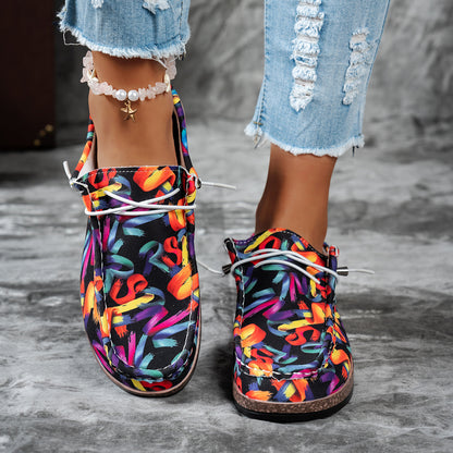 Colorful patterned shoes worn with ripped jeans on a gray surface