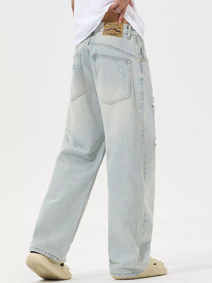 Light blue jeans worn by a person on a white background