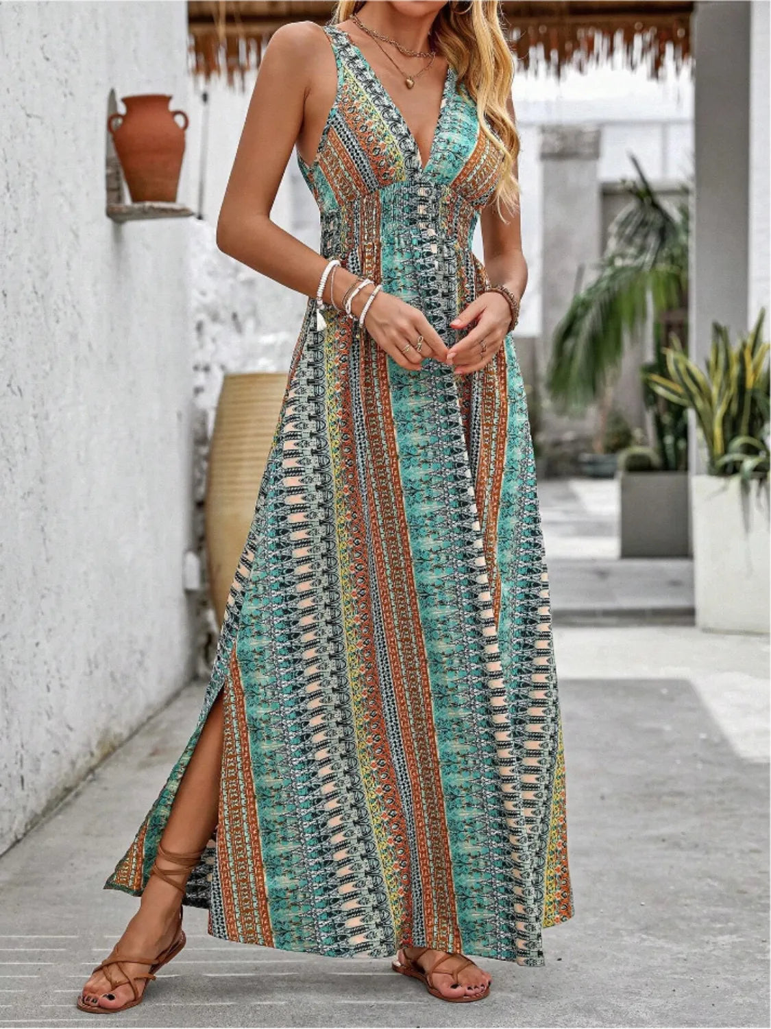 Woman wearing a colorful patterned dress standing outdoors.