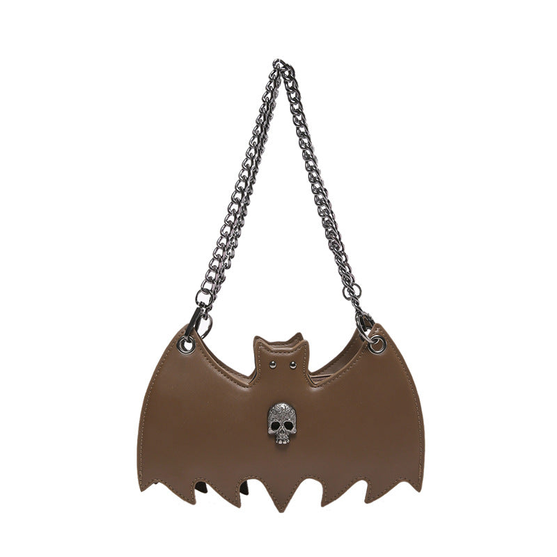 Handbag shaped as a bat on a white background.