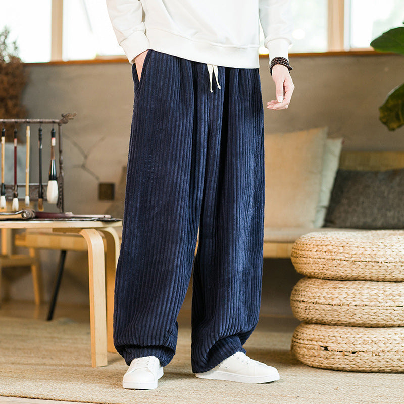 Person wearing blue corduroy pants in a living room setting