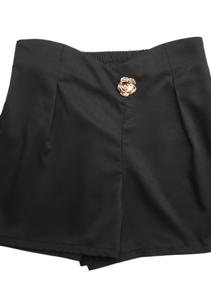 Black shorts with a gold button on a white background
