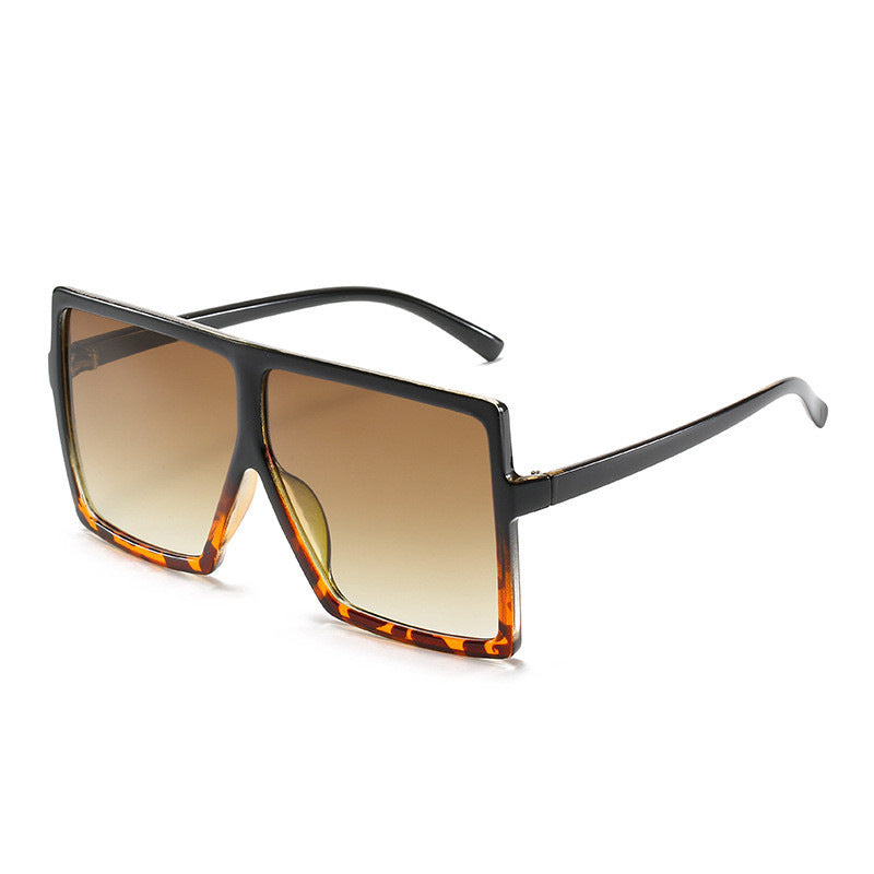 Sunglasses with a gradient brown lens and tortoiseshell frame on a white background