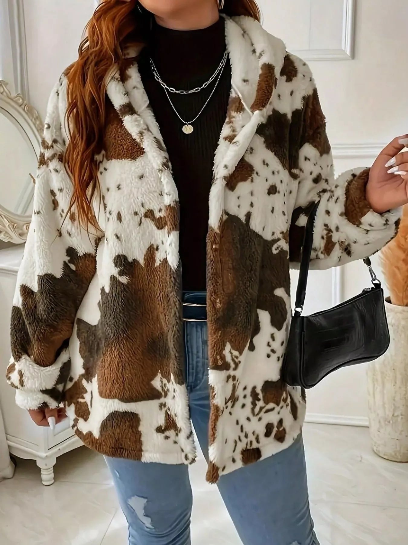 Person wearing a cow print coat in an indoor setting