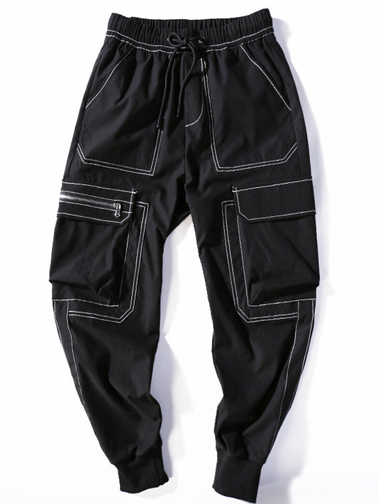 Black cargo pants with white stitching on a white background