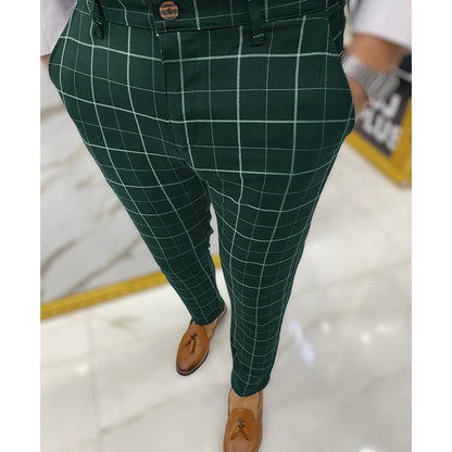 Green checkered pants worn by a person on a light background