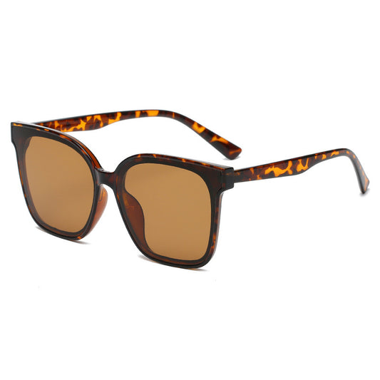 Sunglasses with tortoiseshell frame and brown lenses on a white background
