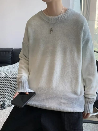 Person wearing a light gray sweater holding a phone indoors.