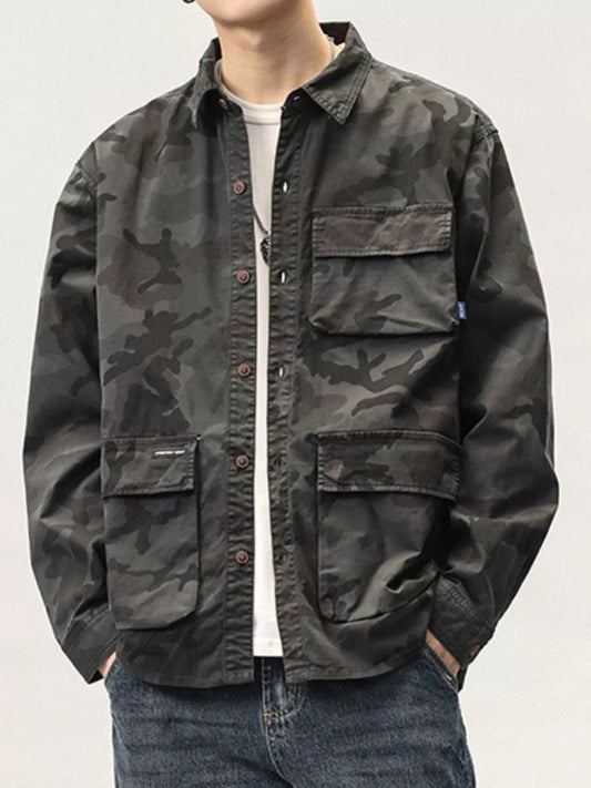 Person wearing a camouflage jacket on a plain background