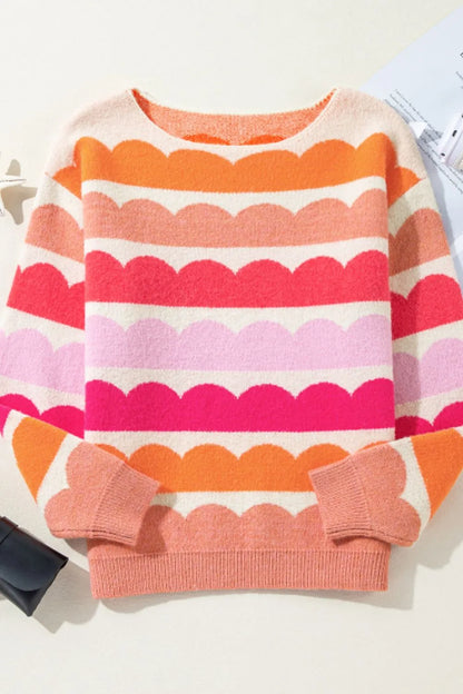 Colorful striped sweater with scalloped edges on a white background