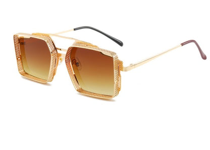 Gold-framed sunglasses with brown gradient lenses on a white background